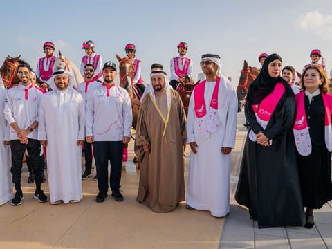His Highness Dr Sheikh Sultan bin Muhammad Al Qasimi with the riders and officials 
