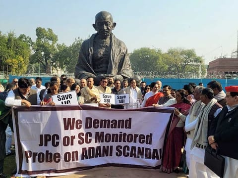 Opposition MPs stage a protest in front of the Gandhi statue demanding a Joint Parliamentary Committee (JPC) probe into the Adani Group issue, at the Parliament premises, in New Delhi on Monday, Feb 6, 2023. 