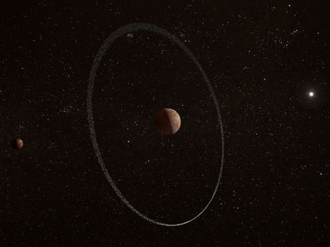  An illustration showing the frigid distant world Quaoar, orbiting in our solar system beyond Pluto, surrounded by its newly discovered ring, along with its moon Weywot. 
