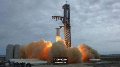This frame grab from a video provided by SpaceX shows a test-firing of the massive engines on the most powerful rocket ever built, designed to send astronauts to the Moon and beyond, at a SpoaceX base in Boca Chica, Texas.  