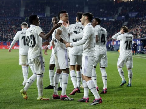 Real Madrid's Marco Asensio celebrates scoring their second goal with teammate Vinicius Junior.