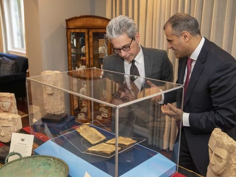 Chase Robinson, director of the Asian art museum’s Freer and Sackler galleries, left, examines artefacts with Yemeni Ambassador Mohammad Al Hadhrami during Tuesday's repatriation ceremony.  