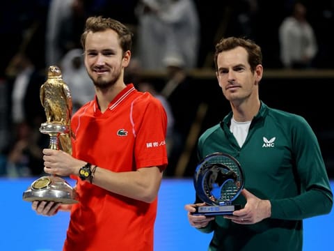 Daniil Medvedev and Andy Murray hold their trophies after the final of the Qatar Open on Saturday.