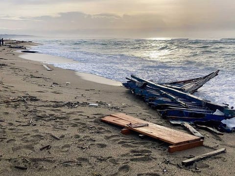 A view of  part of the wreckage of a capsized boat that was washed ashore at a beach near Cutro, southern Italy, Monday, Feb. 27, 2023. Tunisia is a key transit point for tens of thousands of people seeking to reach Europe each year.