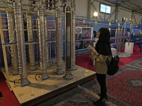 A student looks at Iran's domestically built centrifuges in an exhibition of the country's nuclear achievements, in Tehran, Iran, on February 8, 2023.  