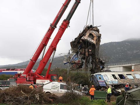 Cranes remove debris after a trains' collision in Tempe, about 376 kilometres north of Athens, near Larissa city, Greece, Thursday, March 2, 2023. 
