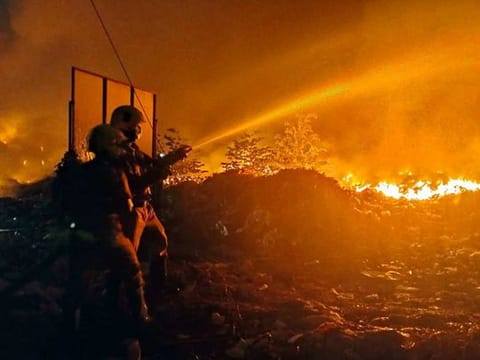 Firefighters try to douse the flames after a massive fire broke out at the Brahmapuram waste plant in Kochi on Saturday, March 4.
