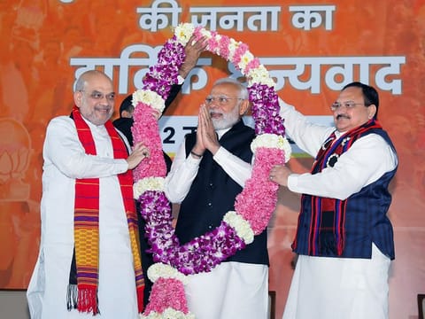 Prime Minister Narendra Modi being garlanded by Bharatiya Janata Party (BJP) President JP Nadda and Home Minister Amit Shah during a celebration function after the party's victory in the Assembly polls in three northeastern states of Tripura, Meghalaya and Nagaland 