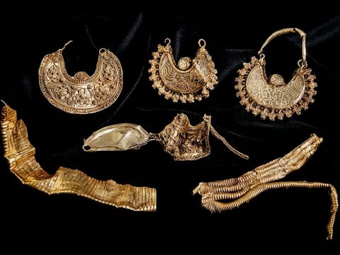 Part of the 1000-year-old medieval treasure discovered in Hoogwoud, Netherlands, consisting of jewellery and silver coins. 
