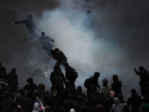 Protesters scuffle at the end of a rally in Paris.  