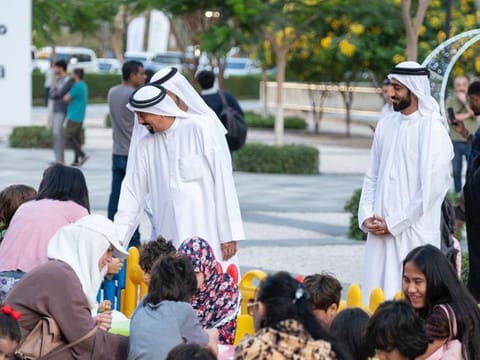 Dr. Hamad Al Sheikh Ahmed Al Shaibani, IACAD Director General, greets residents during the 'Hala Ramadan' campaign in Al Barsha Heights over the weekend. 