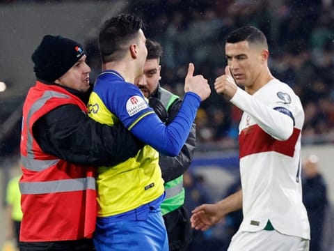 Cristiano Ronaldo (right) winked and gave a pitch invader, dressed in the Al Nassr kit, the thumbs up during Portugal's Euro 2024 qualifier match against Luxembourg at the Stade de Luxembourg, in Luxembourg. 