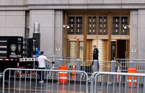Workers with the NYPD set up barricades outside the offices of the Manhattan District Attorney on April 1, 2023 in New York City.  