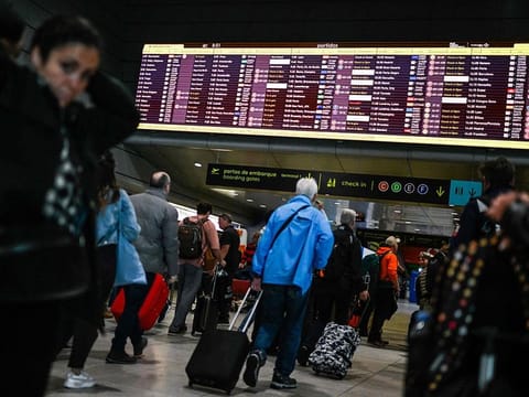 Passengers queue to check-in inside the departures hall during pay-related strike action by EasyJet Plc at Lisbon Airport in Lisbon, Portugal.