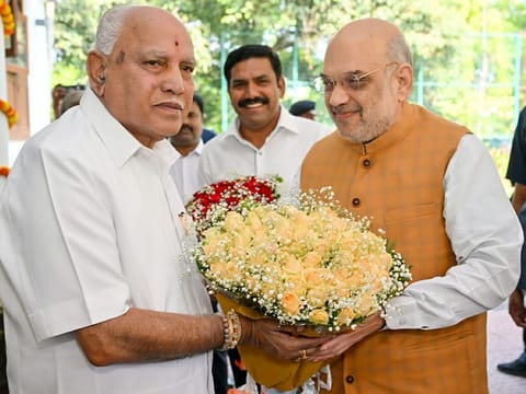 Union Home Minister Amit Shah meets former Karnataka Chief Minister B S Yediyurappa, at the latter's residence, in Bengaluru on Friday. BJP State Vice President and son of  B S Yediyurappa, B Y Vijayendra is also seen. 