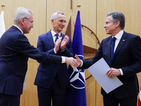 Finnish Foreign Minister Pekka Haavisto, left, shakes hands with United States Secretary of State Antony Blinken, right, after handing over his nation's accession document during a meeting of NATO foreign ministers at NATO headquarters in Brussels, Tuesday, April 4, 2023.  