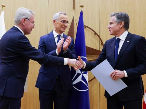 Finnish Foreign Minister Pekka Haavisto, left, shakes hands with United States Secretary of State Antony Blinken, right, after handing over his nation's accession document during a meeting of NATO foreign ministers at NATO headquarters in Brussels, Tuesday, April 4, 2023.  