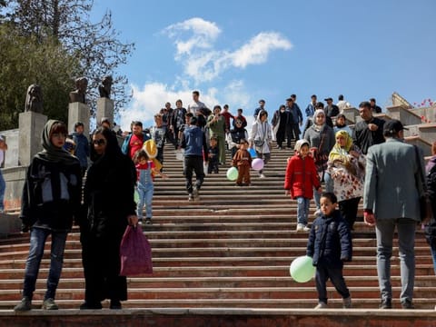 Iranians visit a park on Nature Day in Tehran, on  April 2, 2023. Under Iran’s Islamic sharia law, imposed after the 1979 revolution, women are obliged to cover their hair and wear long, loose-fitting clothes to disguise their figures. Violators have faced public rebuke, fines or arrest.