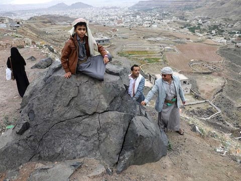 People enjoy the view from a hill overlooking Sanaa as Yemenis live the atmosphere of Ramadan while enjoying a relative calm, the longest stretch in an eight-year civil war, under a UN-brokered truce deal that lapsed in October but had largely held, in Sanaa, Yemen April 2, 2023. 