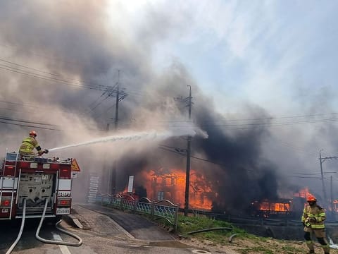 Firefighters work to extinguish a fire in Gangneung, South Korea, Tuesday, April 11, 2023. 