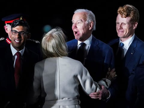 British Prime Minister Rishi Sunak and U.S. Ambassador to the United Kingdom Jane Hartley greet U.S. President Joe Biden next to Joe Kennedy upon Biden's arrival at RAF Aldergrove airbase in County Antrim, Northern Ireland