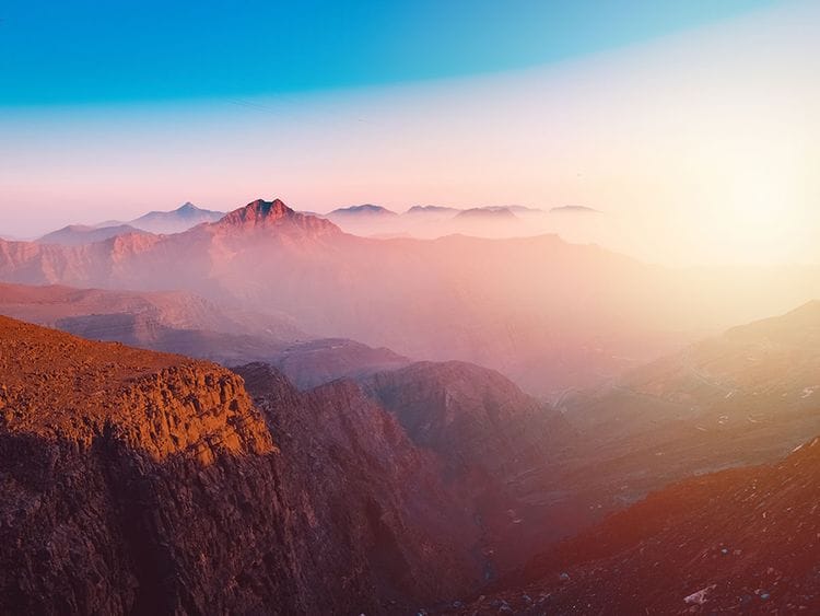A view of the majestic Jebel Jais mountain in Ras Al Khaimah, United Arab Emirates from the highest viewing area during sunset.