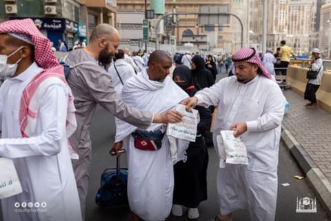 Iftar meal packets are given away to worshippers heading to the Grand Mosque. 