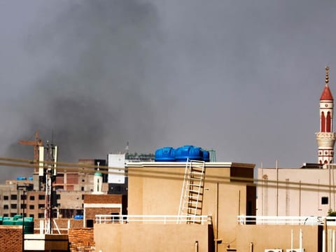 Smoke billows over residential buildings in eastern Khartoum on April 22, 2023, during ongoing battles between the forces of two rival generals.  