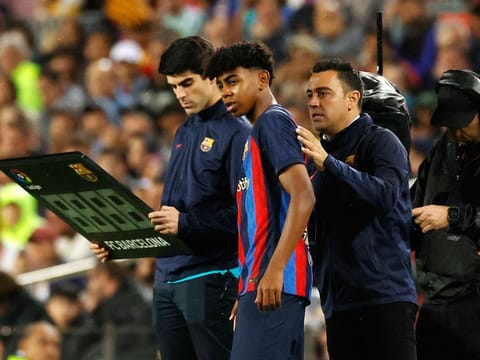FC Barcelona's Lamine Yamal with coach.  15-year-old winger Yamal became Barcelona's youngest-ever player as they beat 10-man Real Betis to move 11 points clear at the top of La Liga.