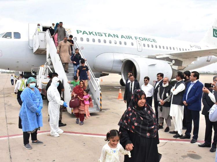 Pakistanis evacuated from Sudan arriving at Karachi airport on April 28, 2023.   