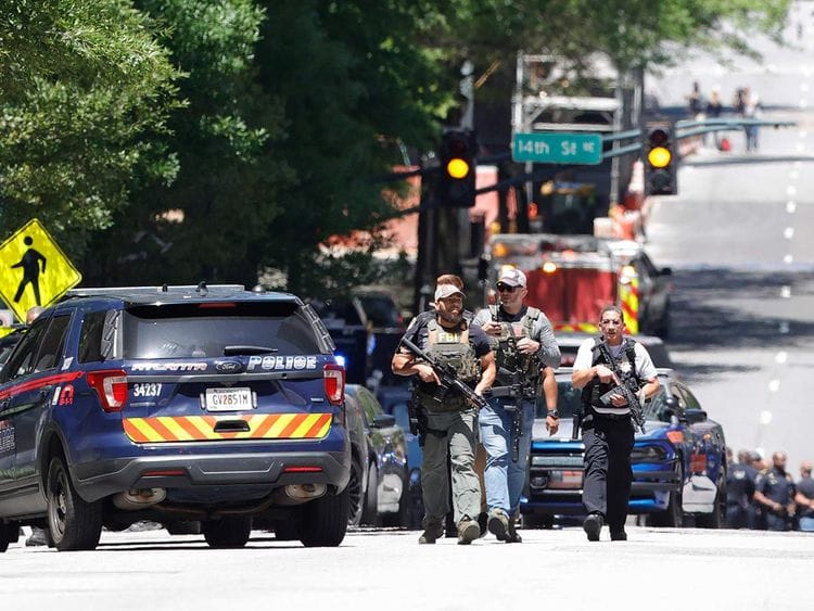 Law enforcement officers arrive near the scene of an active shooter