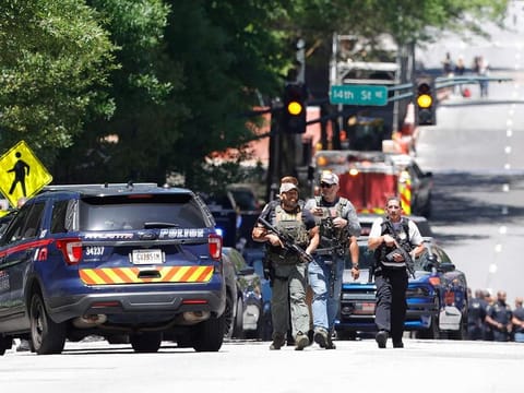 Law enforcement officers arrive near the scene of an active shooter on Wednesday, May 3, 2023 in Atlanta. 