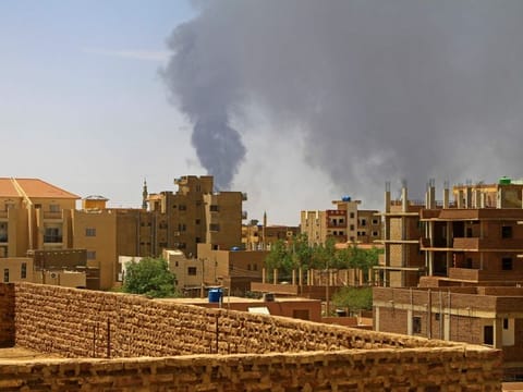 Smoke billows over residential buildings in Khartoum on May 1, 2023 as deadly clashes between rival generals' forces entered third week. 