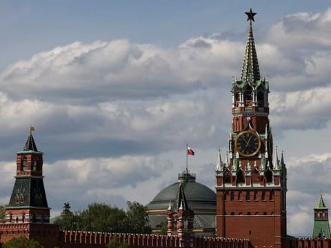 The Russian flag flies on the dome of the Kremlin Senate building behind Spasskaya Tower, in central Moscow, Russia, May 4, 2023. 