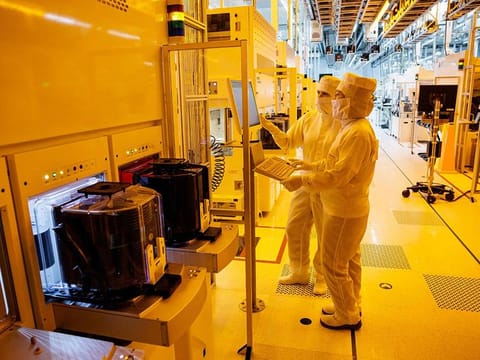 File photo: Employees of German semiconductor manufacturer Infineon Technologies AG work in a clean room on the production line of 200-millimeter wafers at the company's plant in Dresden, eastern Germany. 