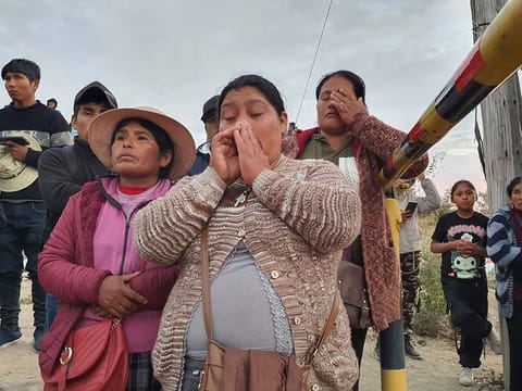 Relatives of trapped miners wait outside the SERMIGOLD mine in Arequipa, Peru