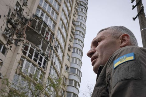 Kyiv Mayor Vitali Klitschko stands in front of an apartment building damaged by a drone that was shot down during a Russian overnight strike, amid Russia's attack, in Kyiv, Ukraine, on May 8, 2023. 