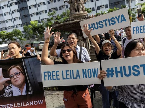 Supporters of former senator Leila de Lima chant "free Leila now" outside the the Hall of Justice where she was acquitted of drugs charge in Muntinlupa City, Philippines, May 12, 2023. 