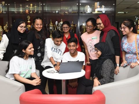 Ishika Khandelwal (seated left), who scored 98.6 per cent, and other Grade 12 students of OIS as they discuss their results. 