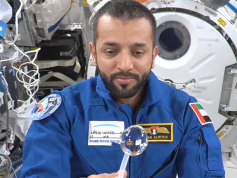 Still from video showing Al Neyadi making a floating water bubble to demonstrate the effect of microgravity on liquids inside the International Space Station
