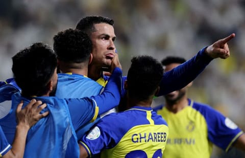 Al Nassr's Cristiano Ronaldo celebrates scoring their third goal.