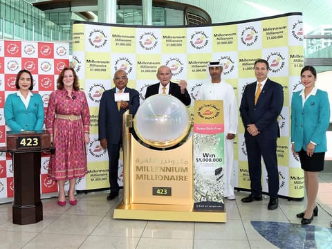 Dubai Duty Free representatives showing the winning ticket picked at the draw on Wednesday at the airport