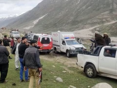 Rescue teams and police officials at the site where an avalanche struck in the Shounter Top area in the Astore district of northern Gilgit-Baltistan region on May 27, 2023.