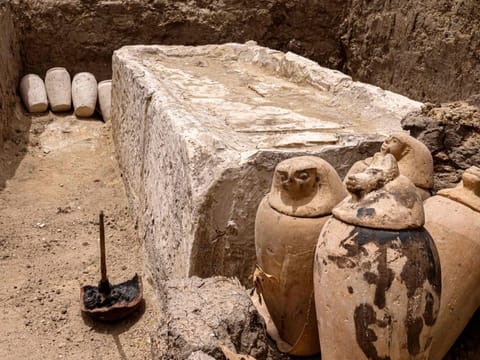 Clay pots and ritual vessels are placed around a stony bed used for mummification, in the Saqqara necropolis south of Cairo, where archaeologists unearthed two human and animal embalming workshops, as well as two tombs, on May 27, 2023.  