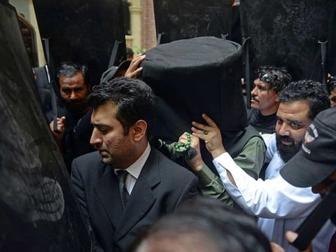 Security personnel with ballistic shields escort former Pakistan's prime minister Imran Khan (C) to the High Court in Lahore on May 30, 2023.  