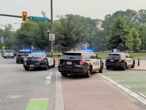 Police vehicles are seen parked near a park where, according to the police, a gunman opened fire, in Richmond, Virginia, on June 6, 2023, in this screen grab obtained from a social media video. 