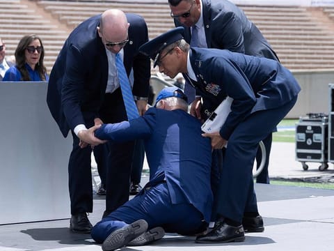 US President Joe Biden is helped up after falling during the graduation ceremony at the United States Air Force Academy, just north of Colorado Springs in El Paso County, Colorado, on June 1, 2023