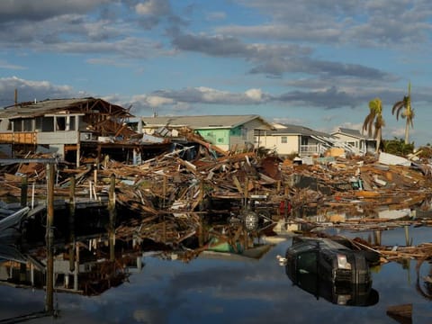 Cars and debris from washed away homes line a canal in Fort Myers Beach, Florida on October 5, 2022, one week after the passage of Hurricane Ian. After months of gradually warming sea surface temperatures in the tropical Pacific Ocean, NOAA officially issued an El Nino advisory on June 8, 2023, and stated that this one might be different than the others. 