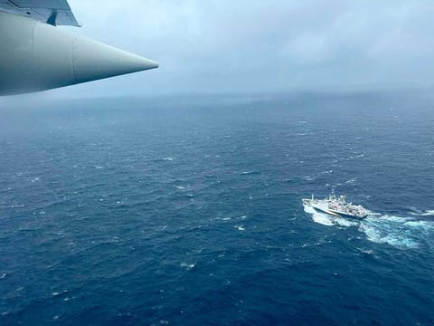 A US Coast Guard HC-130 Hercules airplane flies over the French research vessel, L'Atalante approximately 900 miles East of Cape Cod, during the search for the Titan submersible, on Thursday, June 22, 2023. 