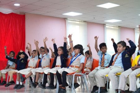 Picture from a workshop aimed at educating children on how to open the door of a school bus and exit it in case they are forgotten inside. 